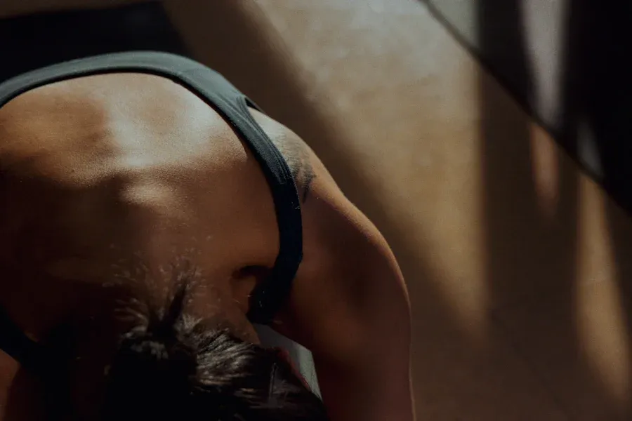 Close-up of someone stretching forward, seen from above